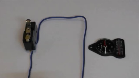 The deflection of a magnetic compass needle by a current in a wire